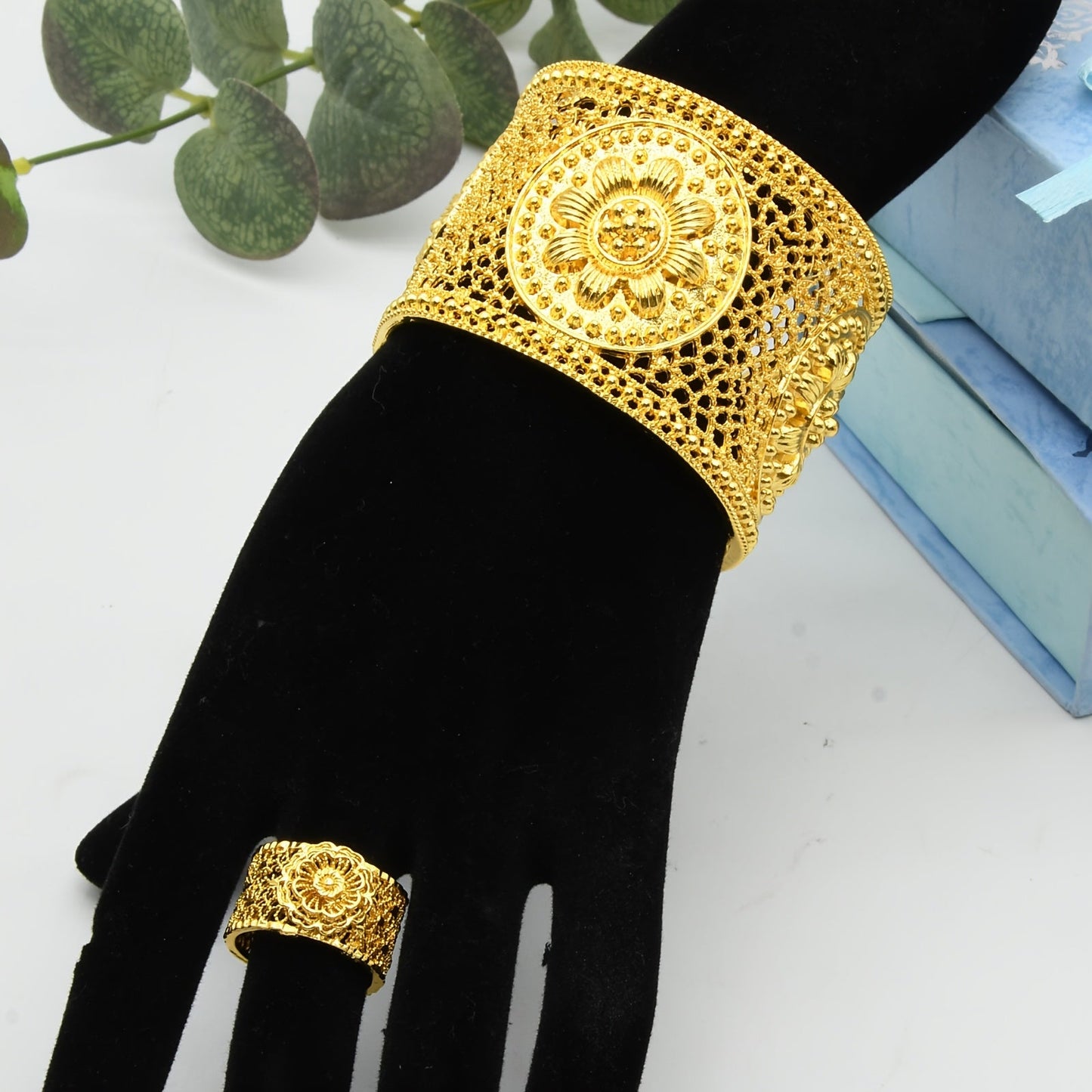 Add a touch of elegance to your outfit with this stunning set featuring a 24K golden plated zinc alloy bangle and ring. The floral design is adjustable, making it perfect for women to wear daily or for special occasions such as parties, engagements