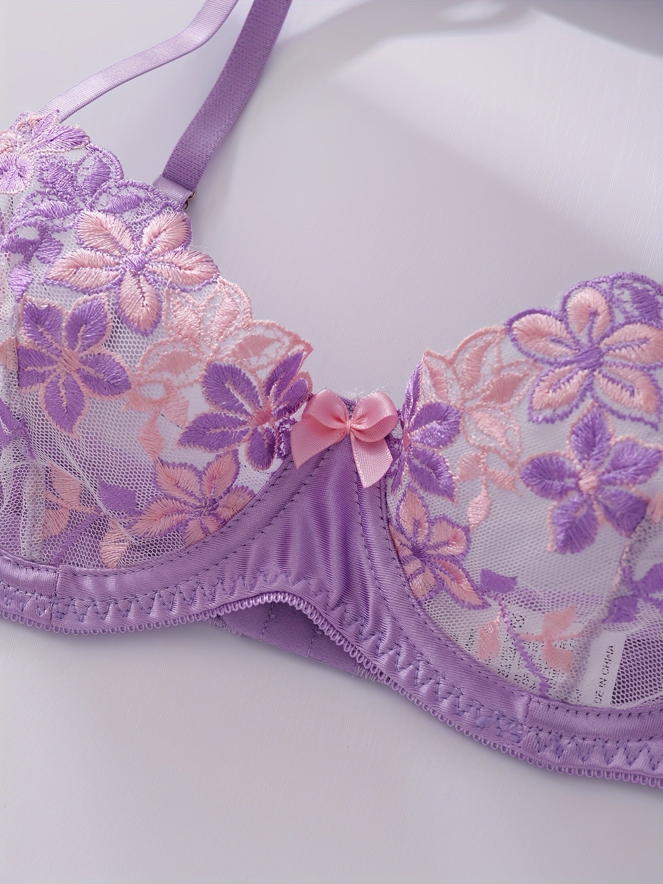 Floral embroidered lingerie set for women, featuring a sexy floral pattern, made from a blend of polyester and elastane. The set includes a medium support bra with underwire and no padding