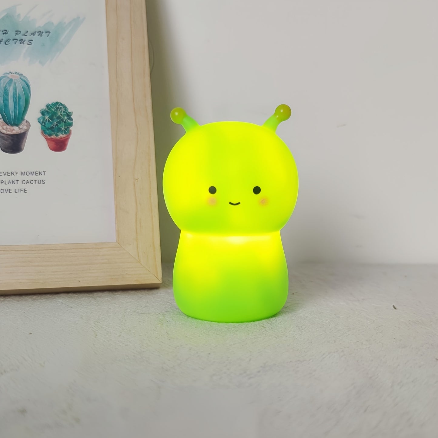 Kid-friendly LED nightlight featuring cartoon dinosaur and bug design in pink and green colors.