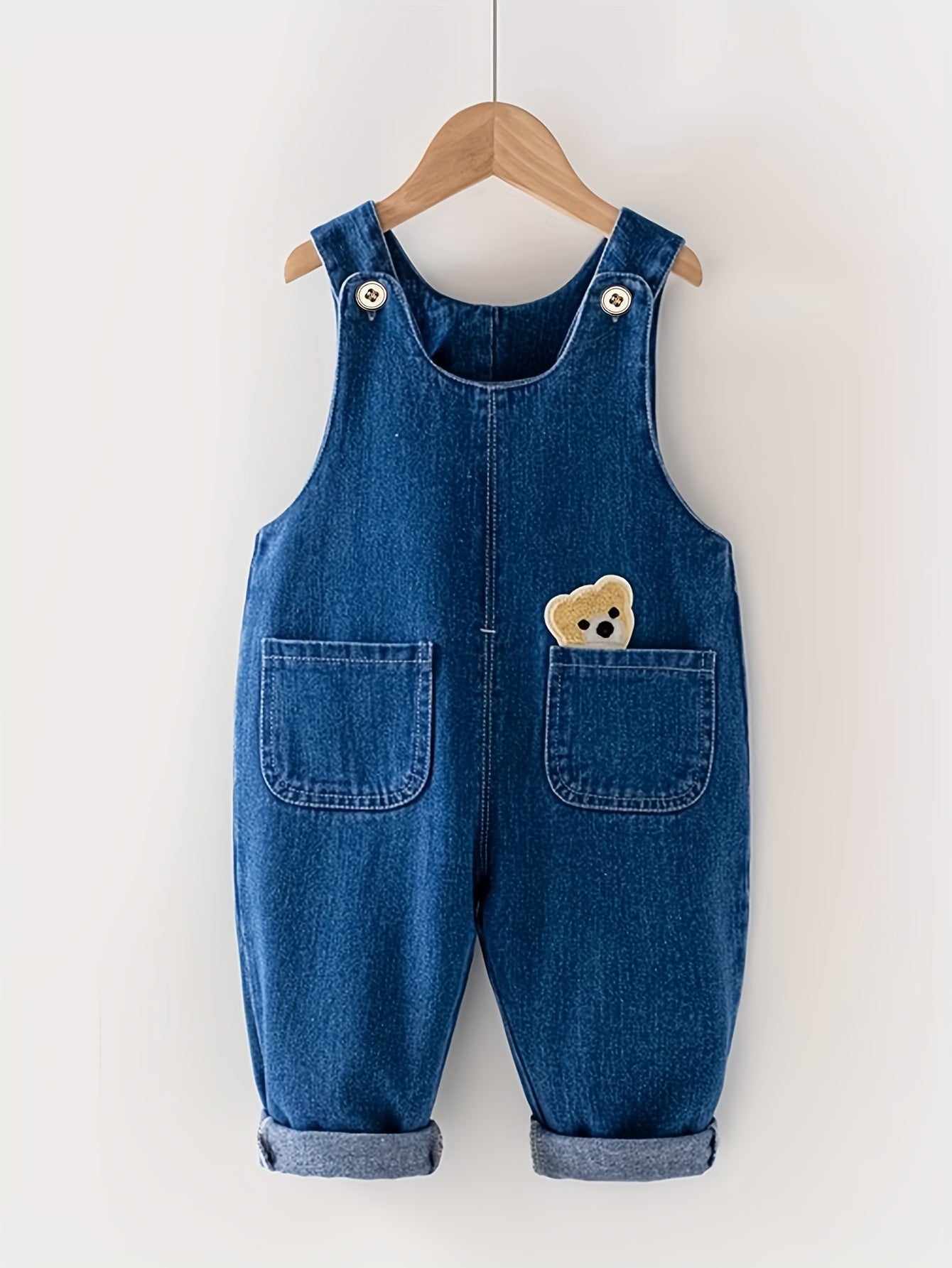 Children's denim overalls with animal pocket detail, made from a cotton blend fabric. Ideal for spring and fall seasons, this unisex toddler jeans romper is perfect for outdoor play.