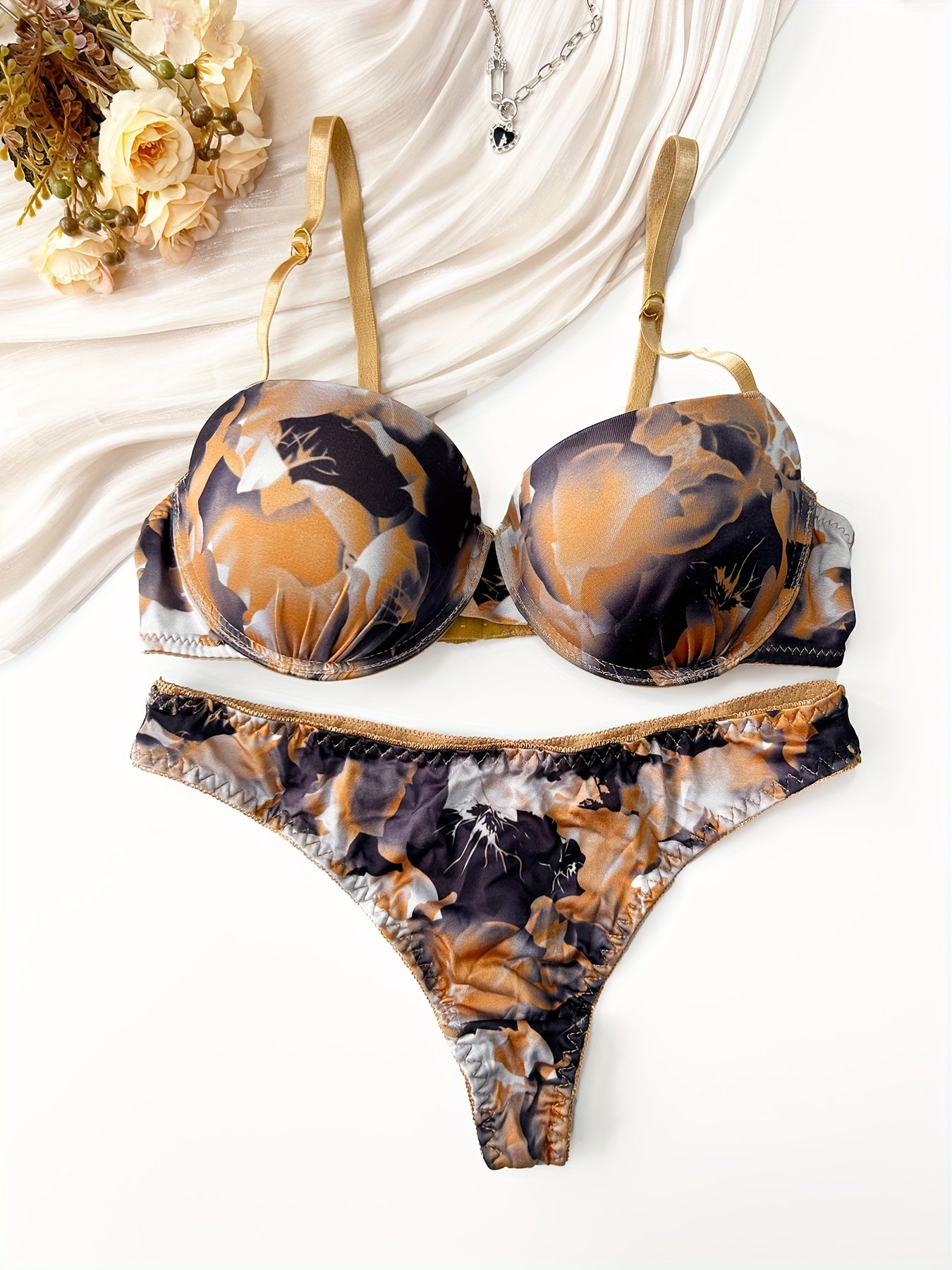 Red and black floral print push-up bra and thong set for women made of comfortable nylon blend. Ideal for casual attire.