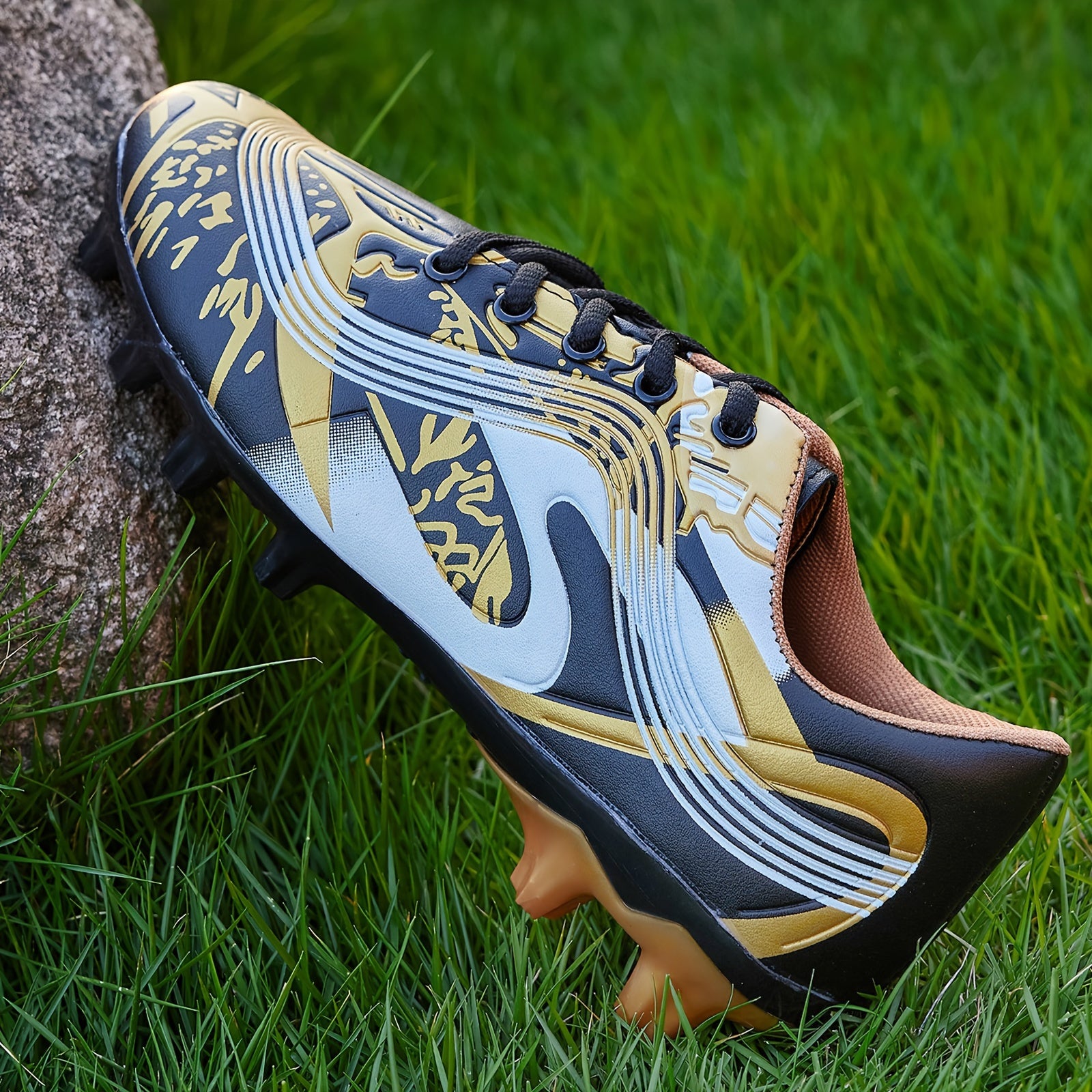 Youth soccer cleats with striped pattern, breathable synthetic upper, and rubber sole for all-season outdoor athletic activities.