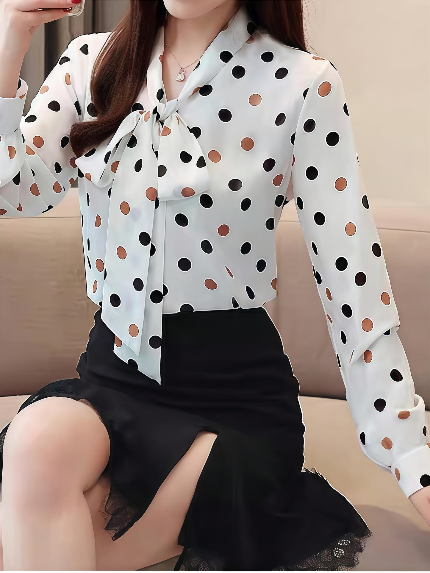 Elegant polka dot blouse with tie-neck detail, perfect for spring and fall.