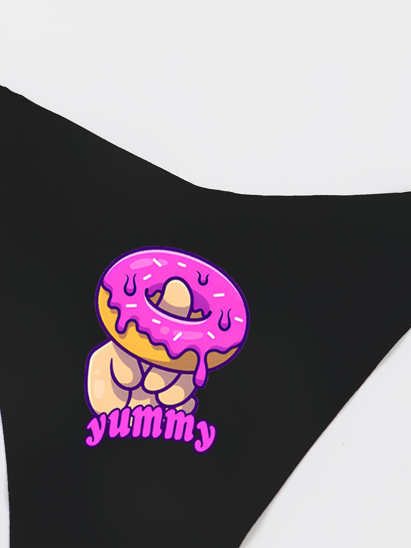 Sexy women's thong underwear featuring donut print and fun letter graphic, made of breathable quick-dry nylon fabric.