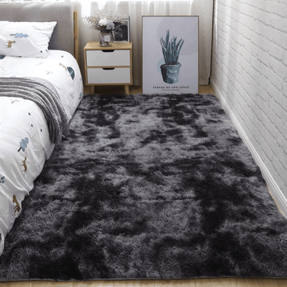 Soft fluffy area rug for bedroom, featuring a non-slip fuzzy shag plush design. This shaggy bedside rug is perfect for girls, kids, babies, teens, and dorm rooms. The tie-dyed pattern adds a fun touch to any living room or nursery. Measures 31.5*62.99