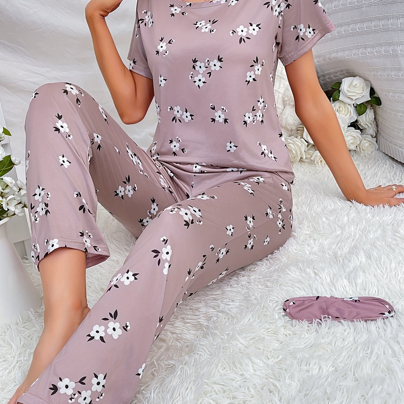 Women's floral pajama set with short sleeve top and elastic waistband pants.