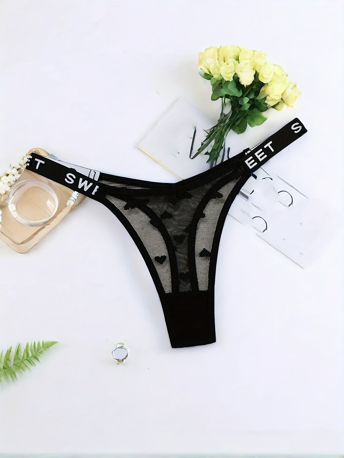 Stylish polyamide blend thong underwear with heart pattern, mesh design, and comfortable stretch fit.