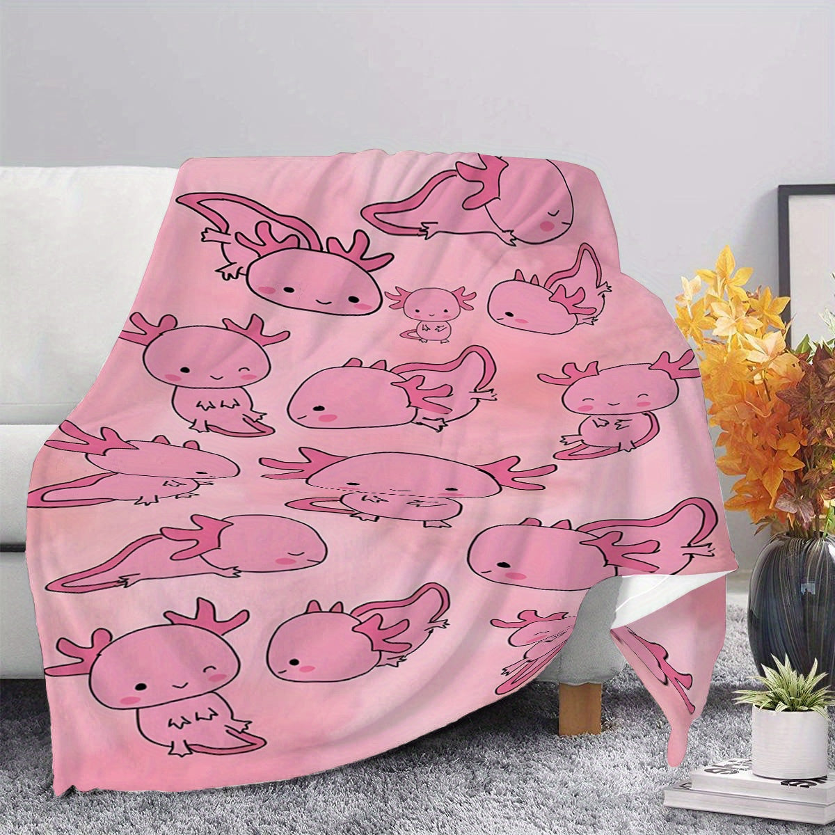 Soft, warm, and lightweight pink cartoon salamander print fleece blanket made of comfortable polyester flannel. Ideal for travel and versatile for all seasons, this contemporary style blanket is the perfect gift for boys, girls, and adults. Machine