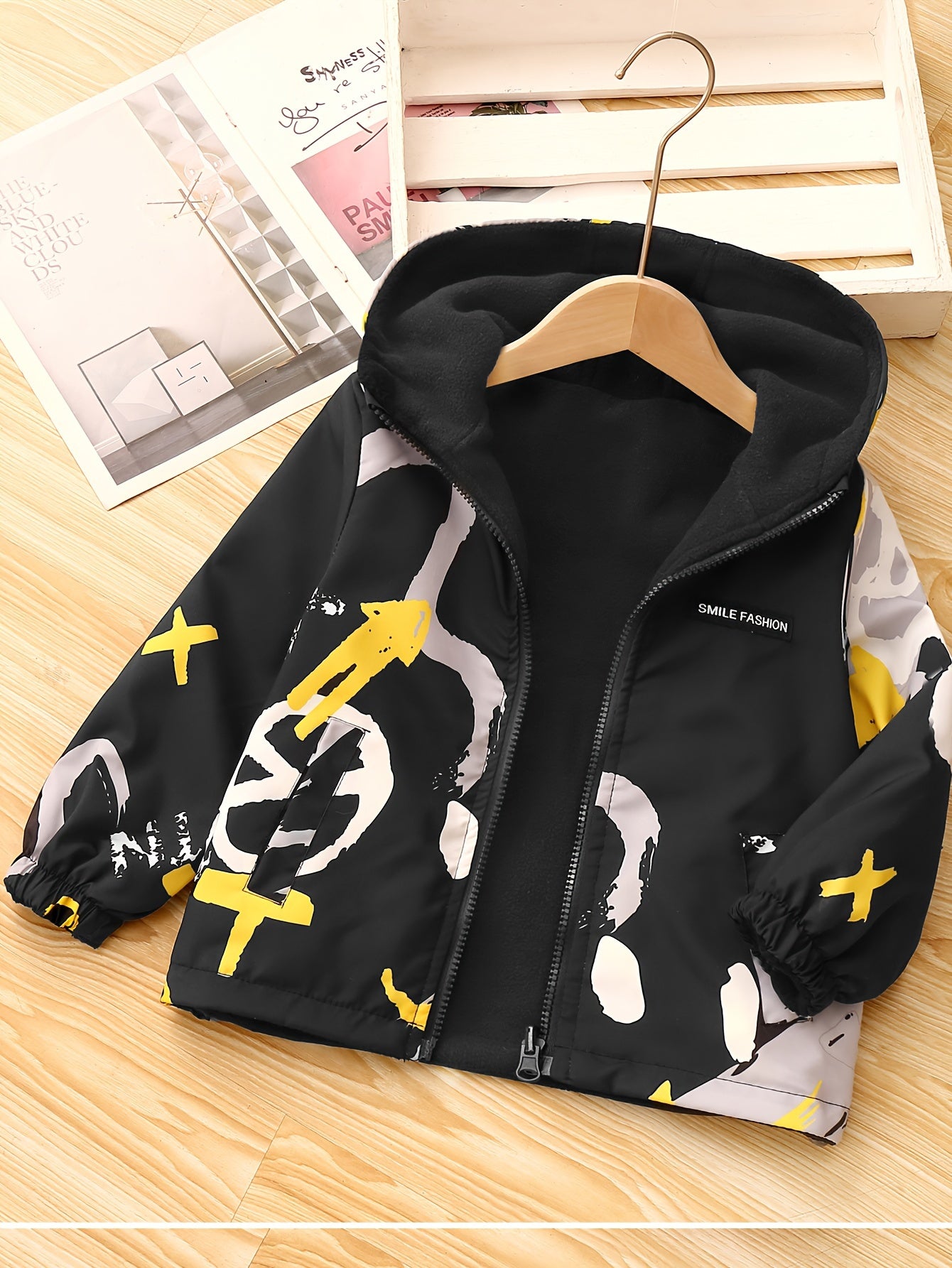 Children's reversible geometric pattern fleece jacket with zip-up hood. Perfect for fall and winter outdoor activities. Great as a gift for boys.