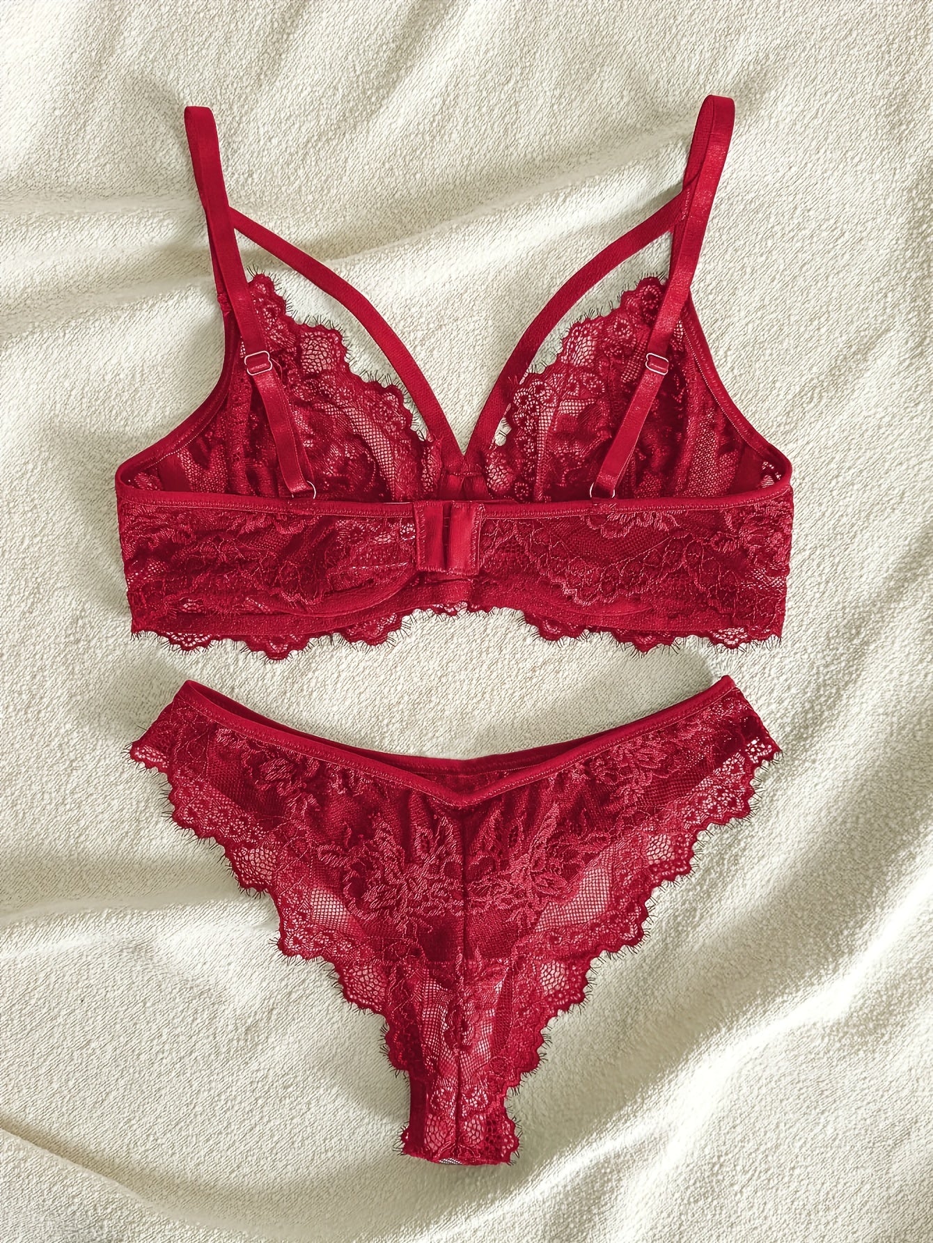 Women's semi-sheer lace lingerie set with underwire bra, mid-rise panties, and no padding.