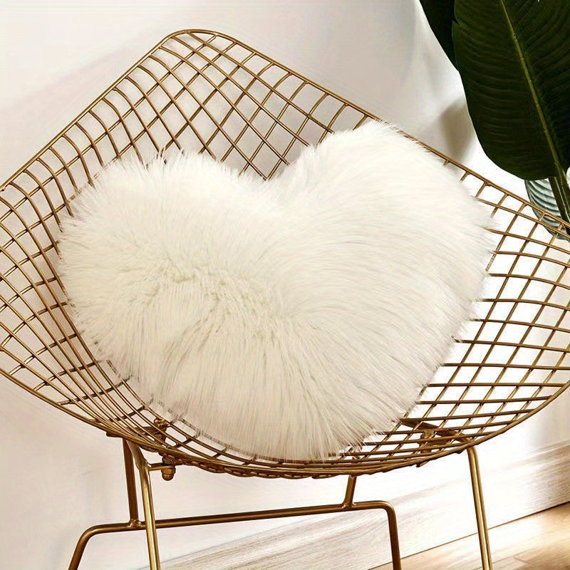 Heart-shaped throw pillow for living room or bedroom, made of long plush material for softness and comfort.