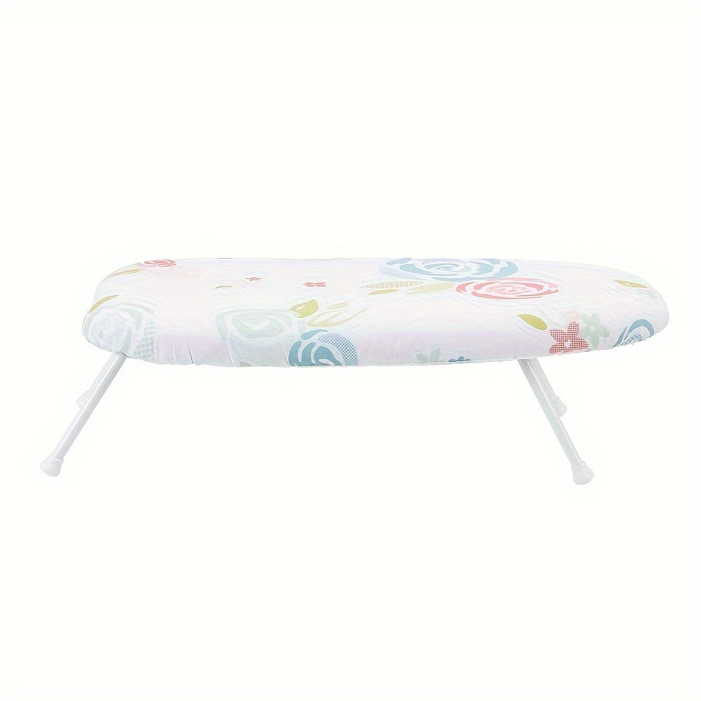 This foldable ironing board features a floral pattern design and is made of thick, high-temperature resistant material. It has a space-saving design with a hanging option, and comes in white with colorful flowers. Measuring 58.42cm x 35.56cm, this