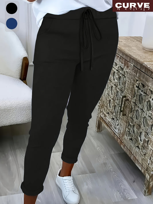 Women's plus size solid color straight leg pants with pockets, drawstring, and relaxed fit for casual wear.