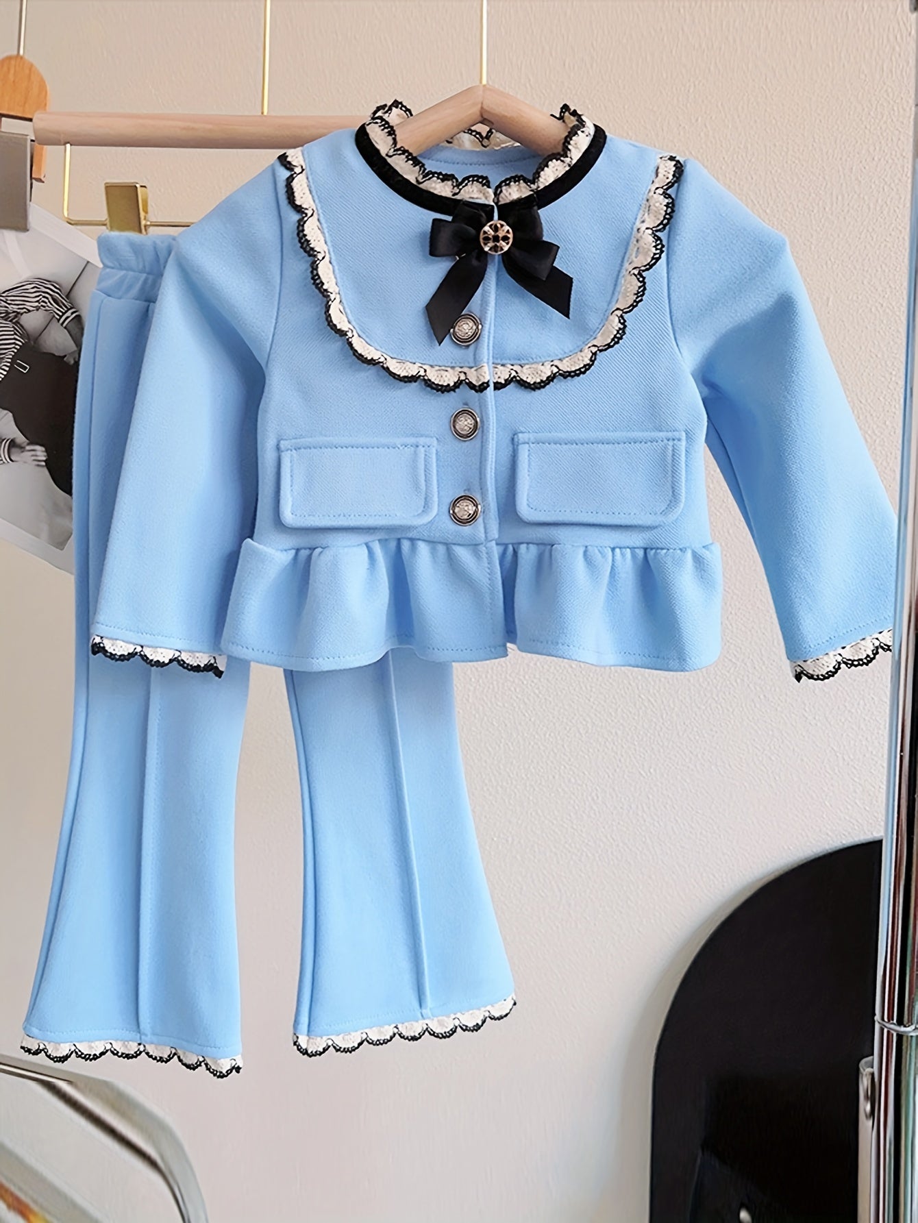 Stylish 2-piece girl's outfit includes frilled cardigan top and flared trousers for outdoor activities in spring/fall.