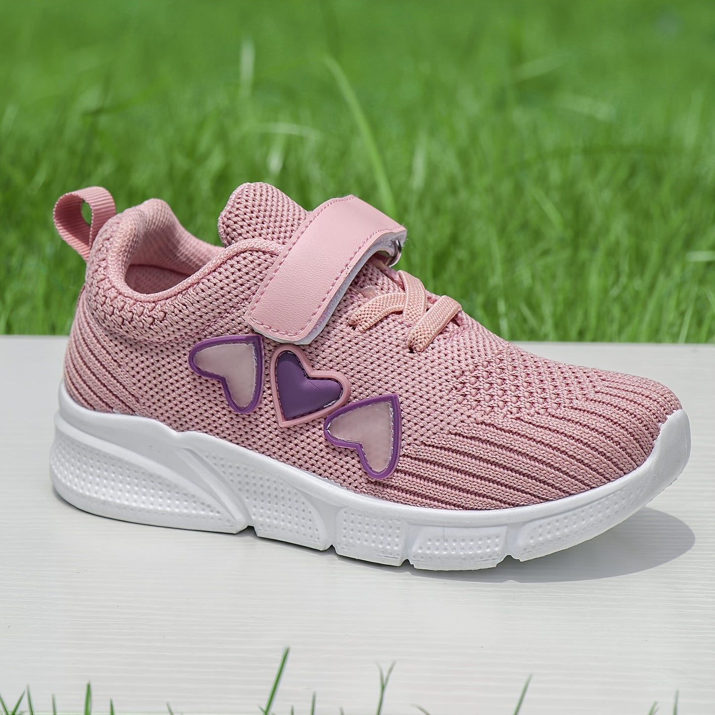 Kids' pink heart design athletic sneakers with breathable knit upper, secure hook-and-loop closure, non-slip rubber sole, perfect for running and walking all year round.