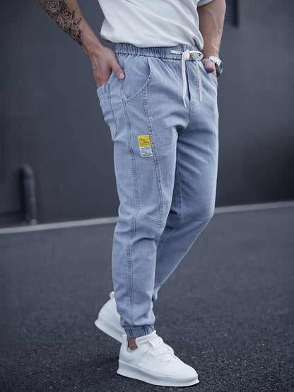 Trendy men's tapered jeans with waist drawstring