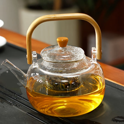 Glass teapot with bamboo handle and removable infuser, 34oz capacity. Made of heat-resistant clear borosilicate glass. Ideal for brewing loose leaf tea.