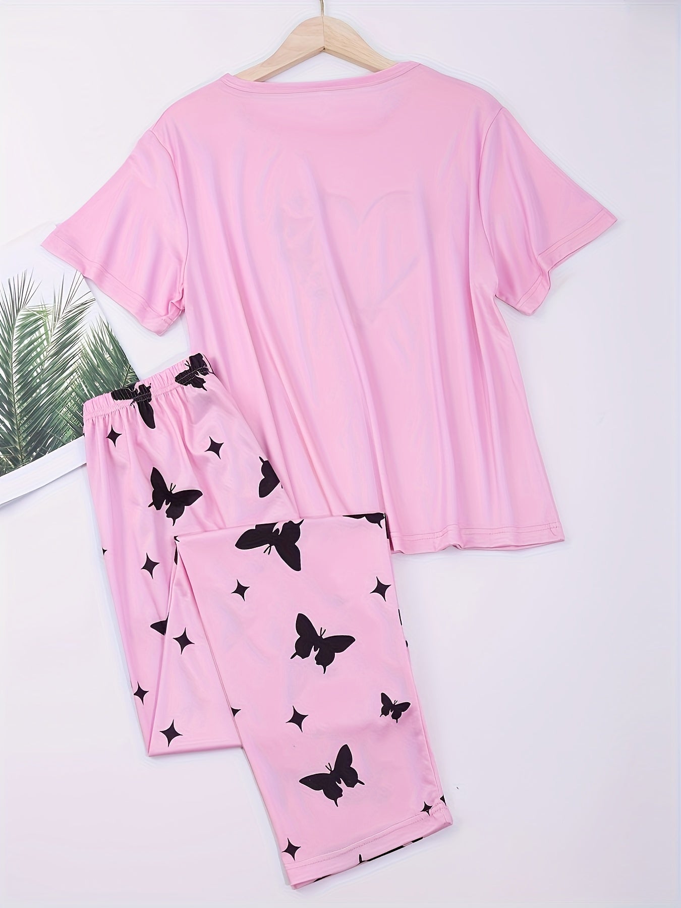 Heart and butterfly print pajama set for women, including a short sleeve top and loose long pants for lounging and sleeping.