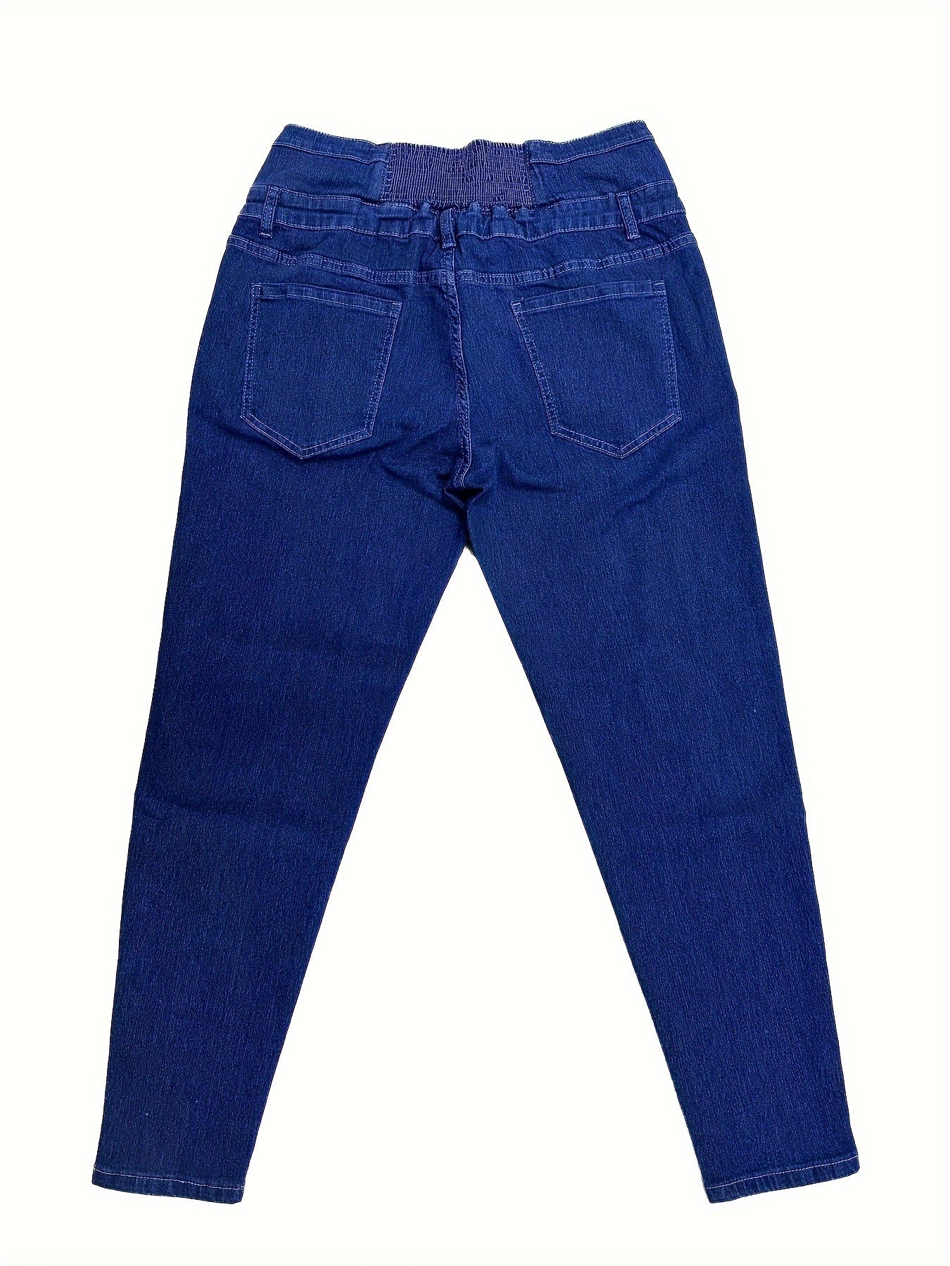 High-waisted skinny jeans with button detail for plus size women, in blue denim.