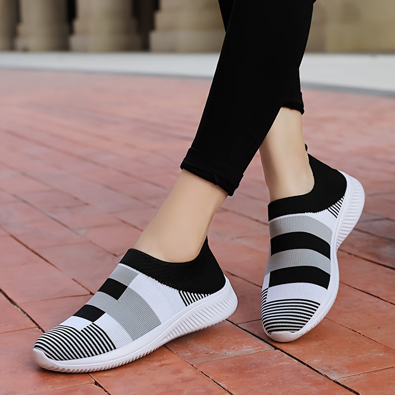 Breathable mesh slip-on sneakers for plus size women in pink, gray, and white plaid with soft sole and round toe design, suitable for all seasons.