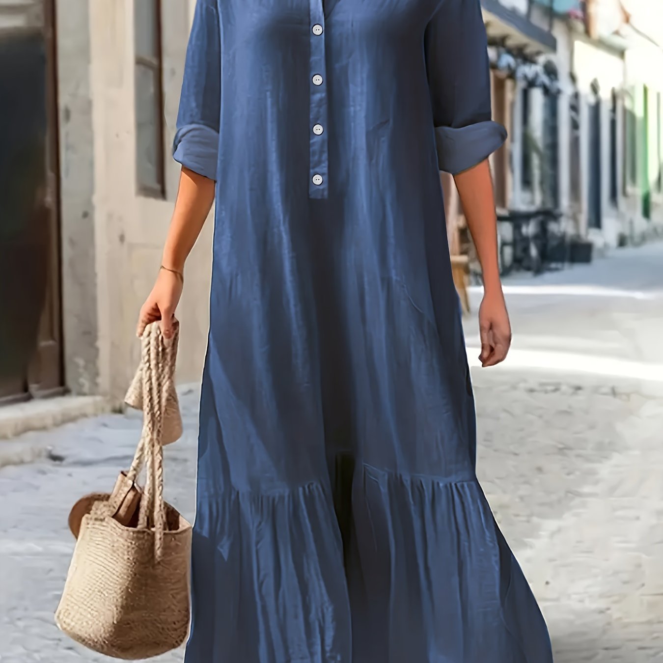 Maxi denim dress in washed blue for plus-size women, with ruffled hem and button-up long sleeves.