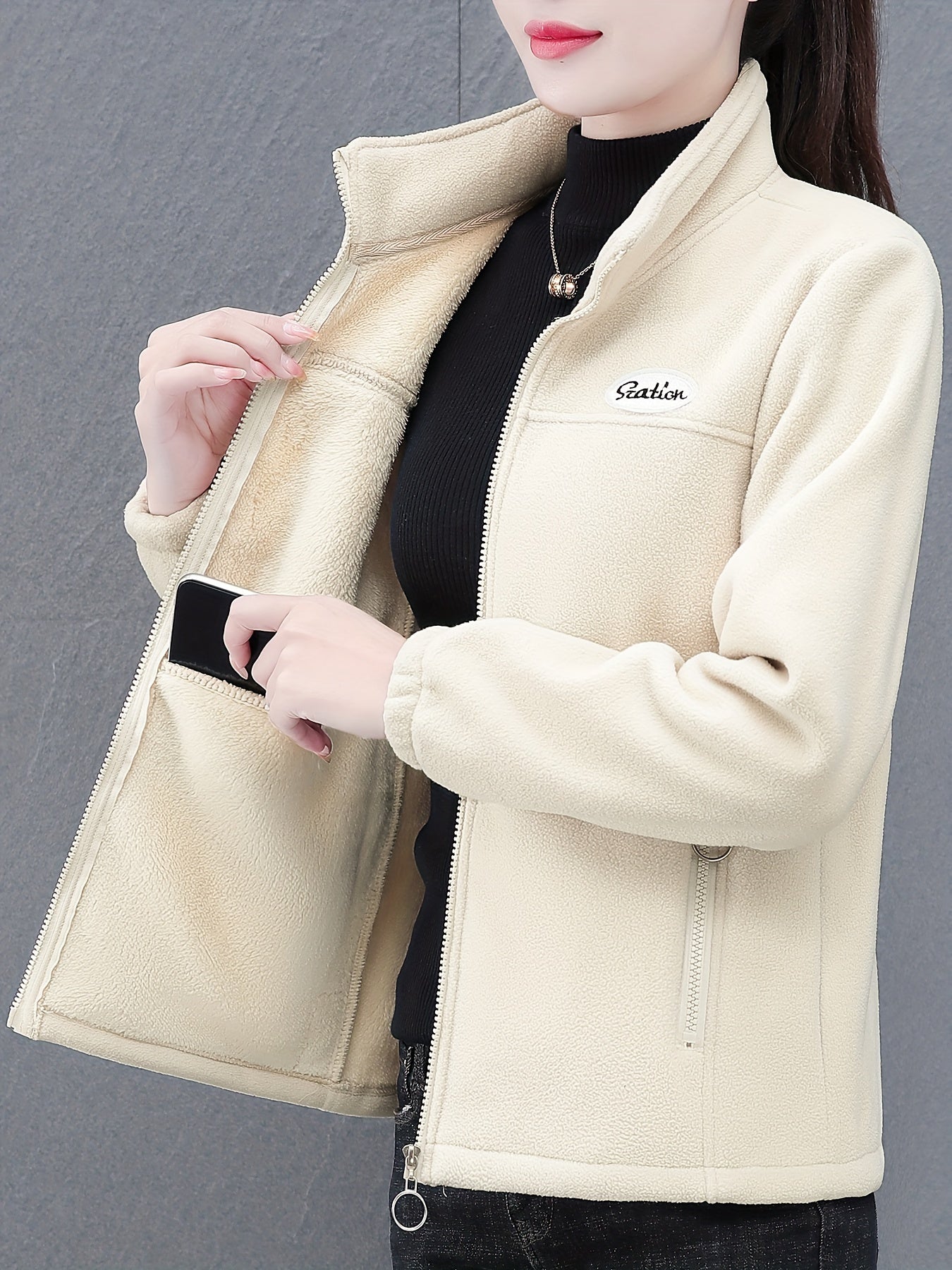 Women's casual fleece jacket with alphabet pattern, stand collar, long sleeves, regular fit, oversized, and zipper detail.