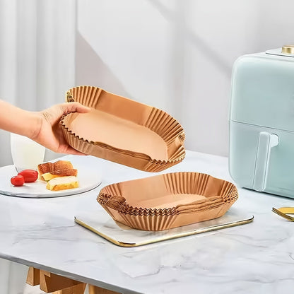 A set of 100 Non-Stick Disposable Air Fryer Liners made from oil-resistant parchment paper. These trays are oven safe and are kitchen accessories that provide chemical-free cooking supplies.