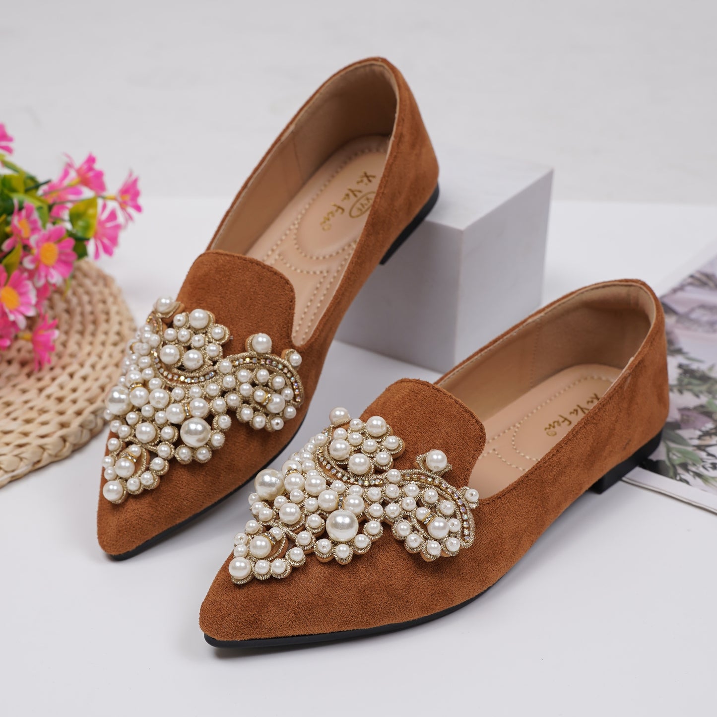 Women's elegant flat shoes with faux pearl decoration, point toe design, and lightweight comfort.