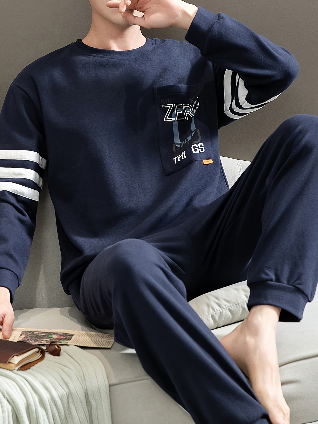 Casual cotton pajamas set for men with letter graphic print, long sleeve crew neck top with chest pocket and loose pants. Suitable for spring and autumn.