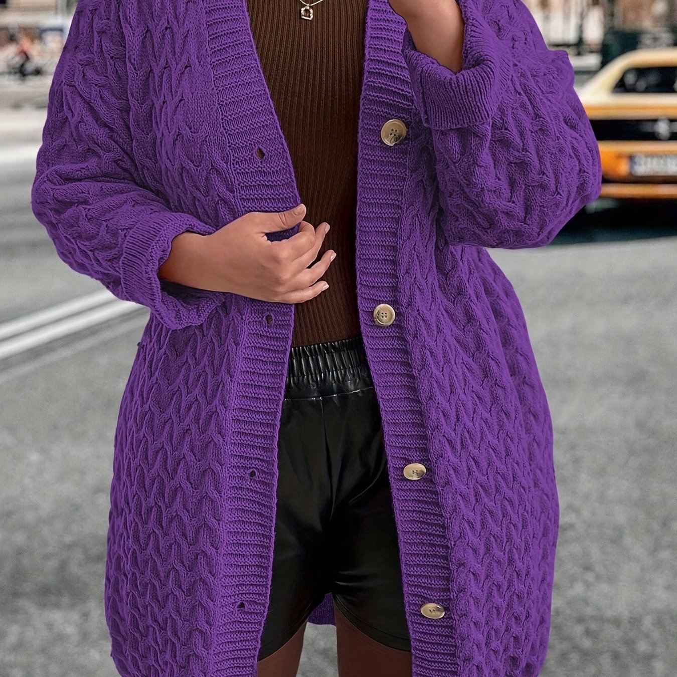 Stylish women's purple cable-knit cardigan with long sleeves, V-neck, and button-up closure. Made of 100% polyester, ideal for fall and winter.