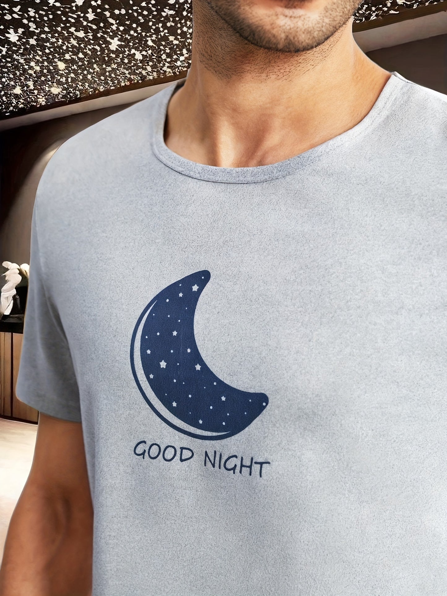 Men's moon and slogan graphic tee and galaxy print shorts pajama set made from polyester with crew neck, medium stretch, random print, regular fit, knit fabric, and elastane composition.