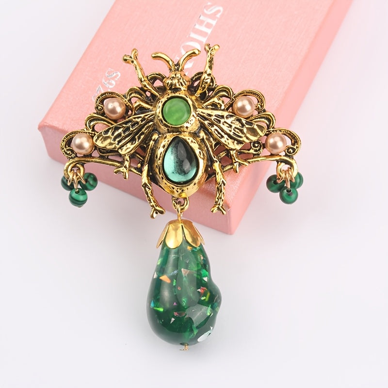 Bee brooch pin with vintage-inspired butterfly design, adorned with rhinestones and intricate green enamel accents, perfect for adding flair to coats and dresses.