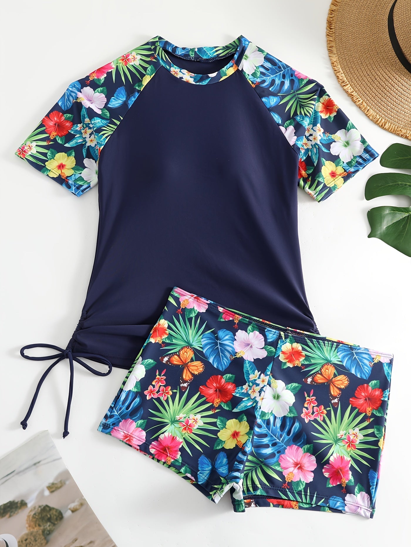 Two-piece tropical plant print rush guard tankini set with sun protection top and boxer shorts swimsuit for women's surfing and water sports.