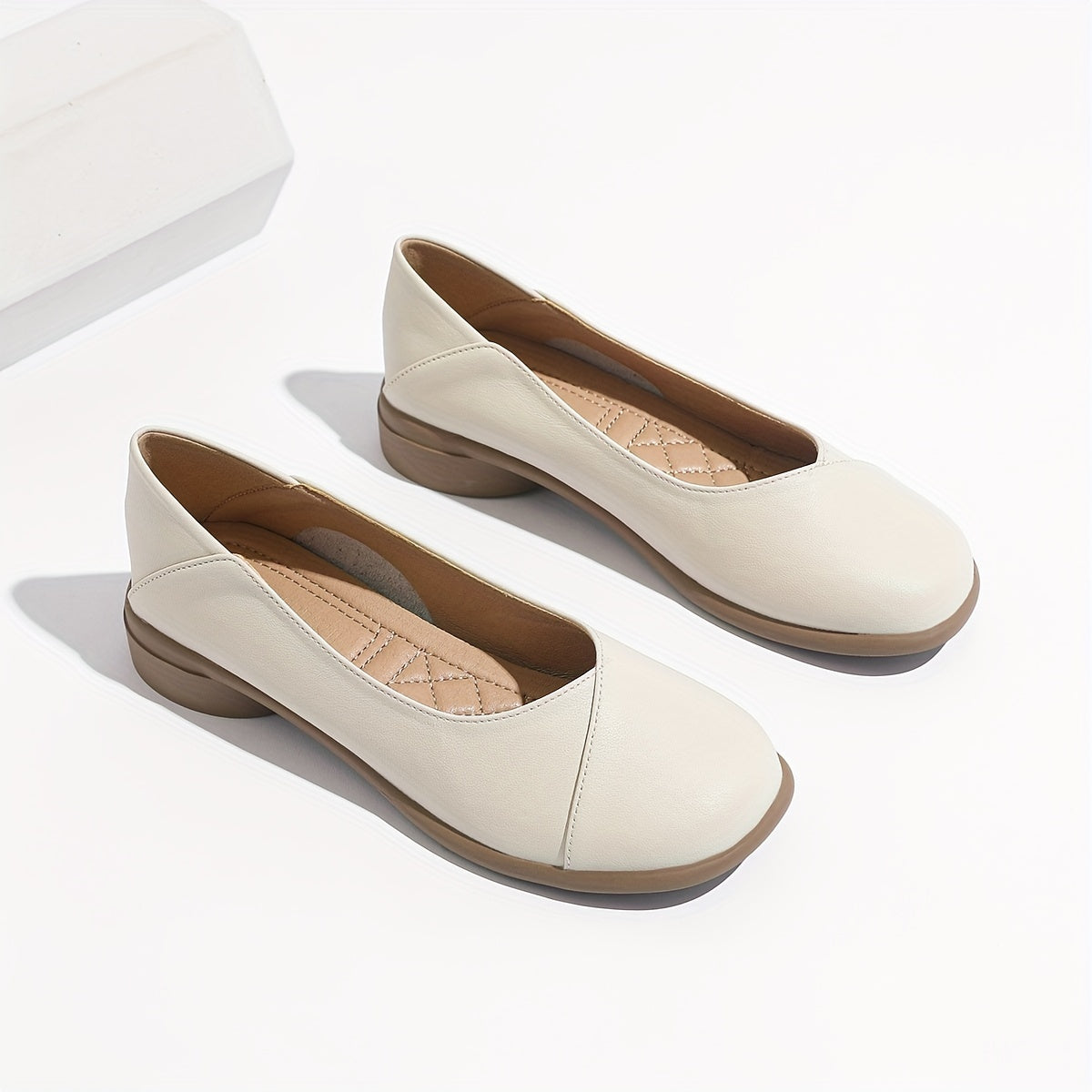 Stylish white low heel flats with all-day comfort for work.