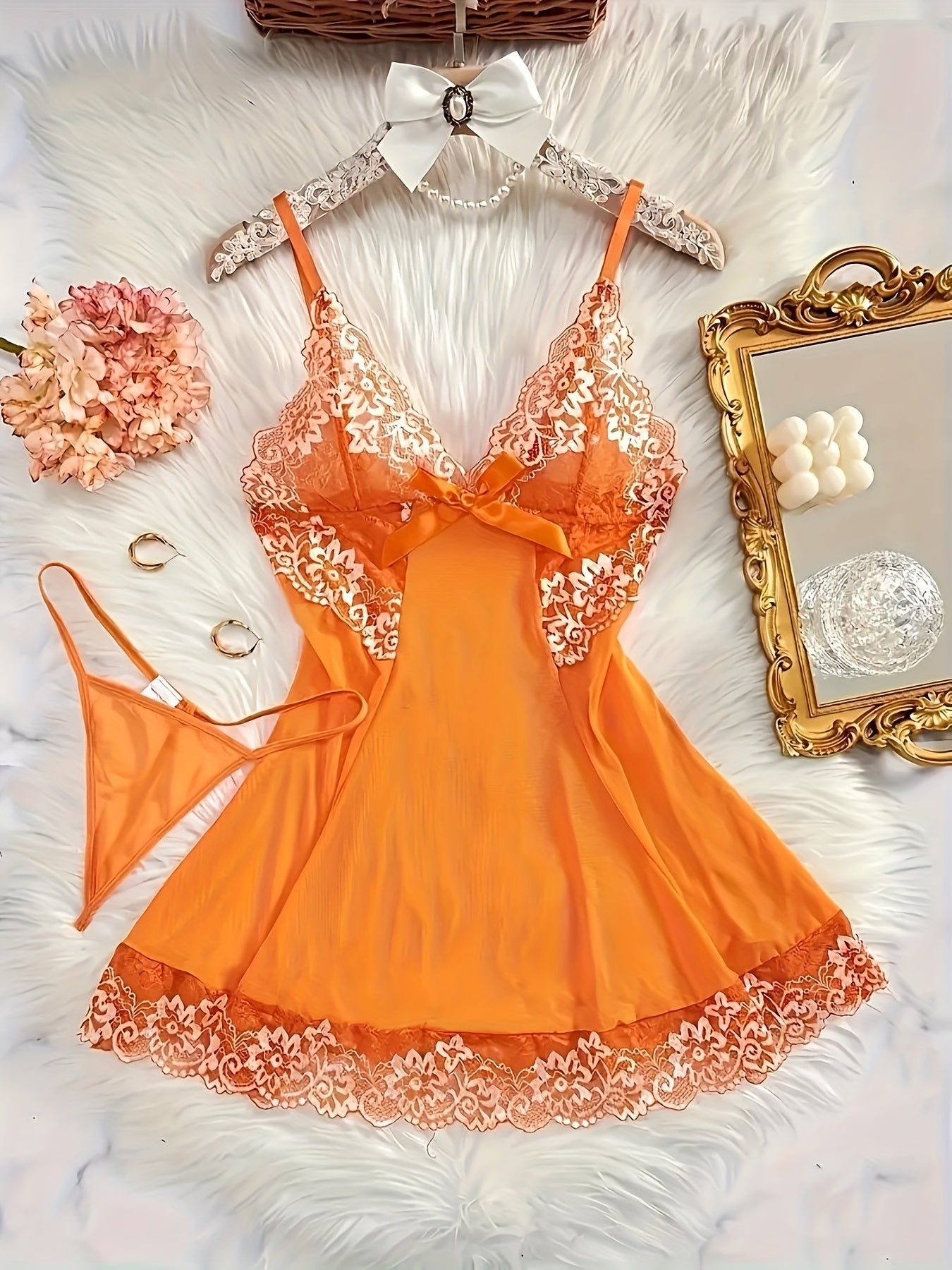 Sexy women's dress with deep V neckline, thin straps, bow decoration, and matching thong.