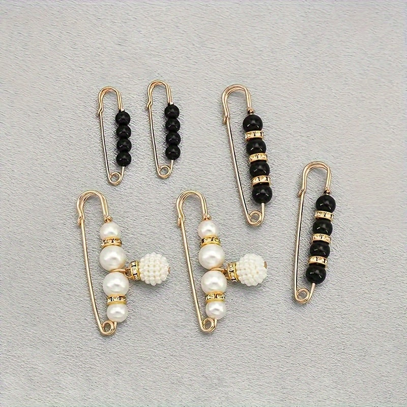 6 elegant artificial pearl brooches in black and white, perfect for any outfit.