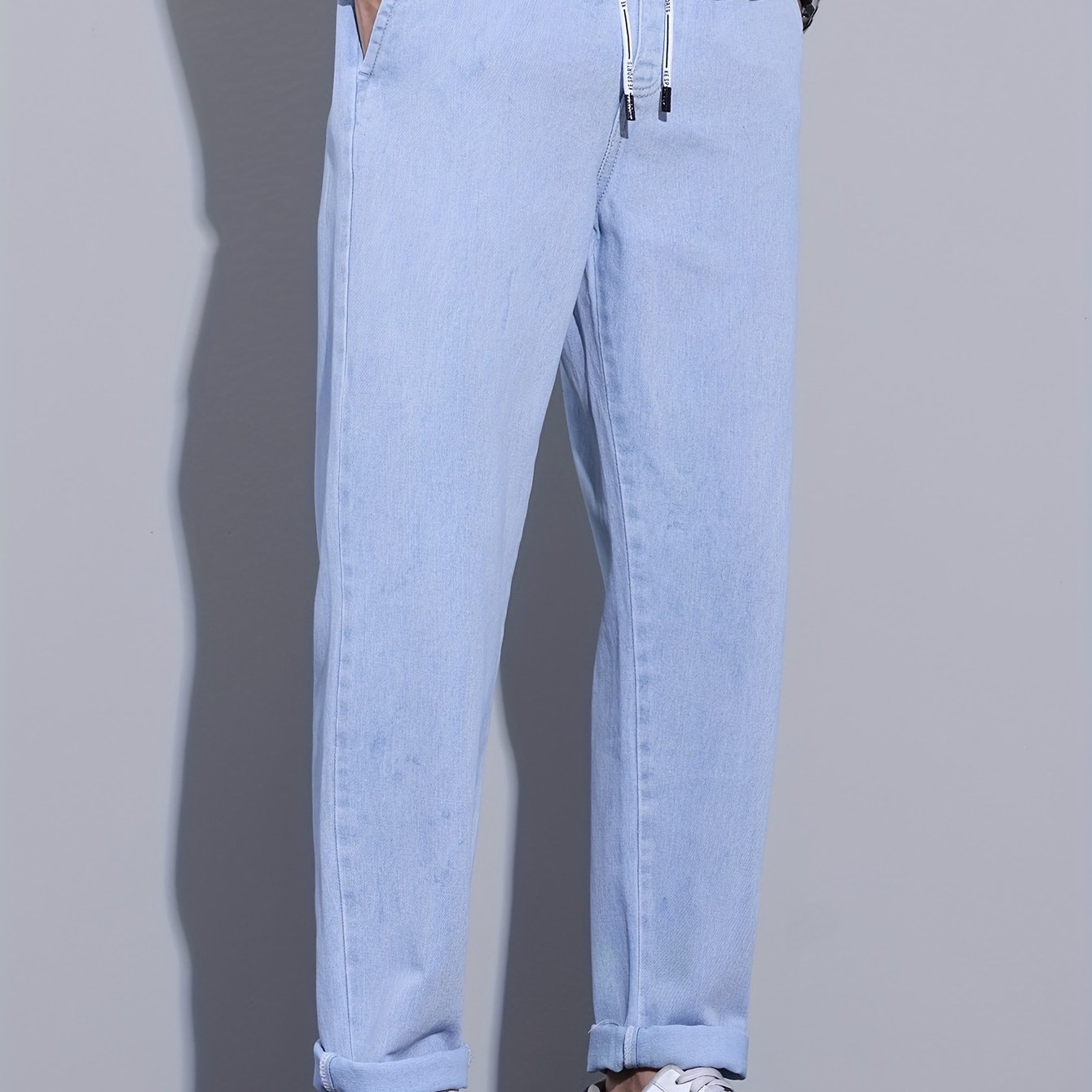 Men's light blue drawstring waist straight-leg jeans in glossy fabric, perfect for all seasons.