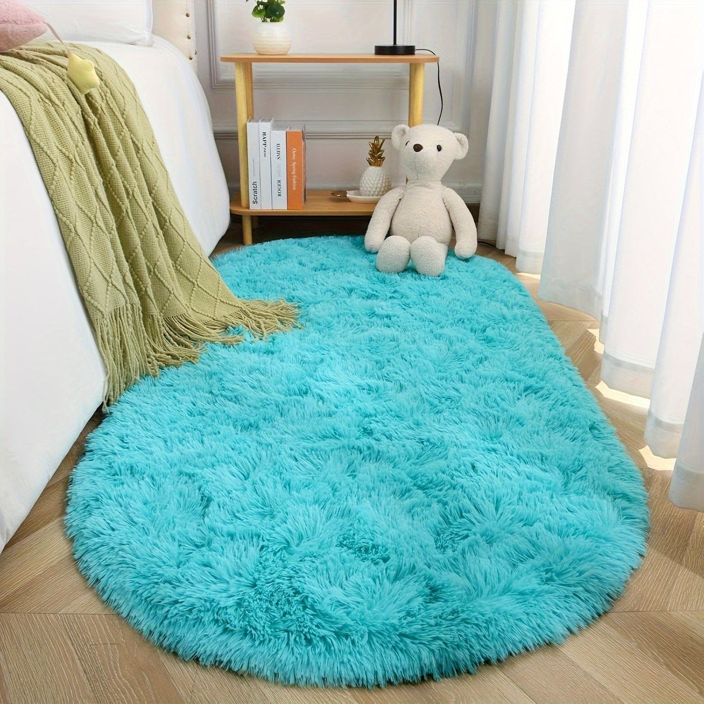 Soft and fluffy oval shaggy area rug, perfect for bedroom or living room. Made with skin-friendly thickened sponge and tufted polyester material. Durable and easy to maintain. Adds decorative touch to indoor spaces such as sofa, bedside, playroom, or