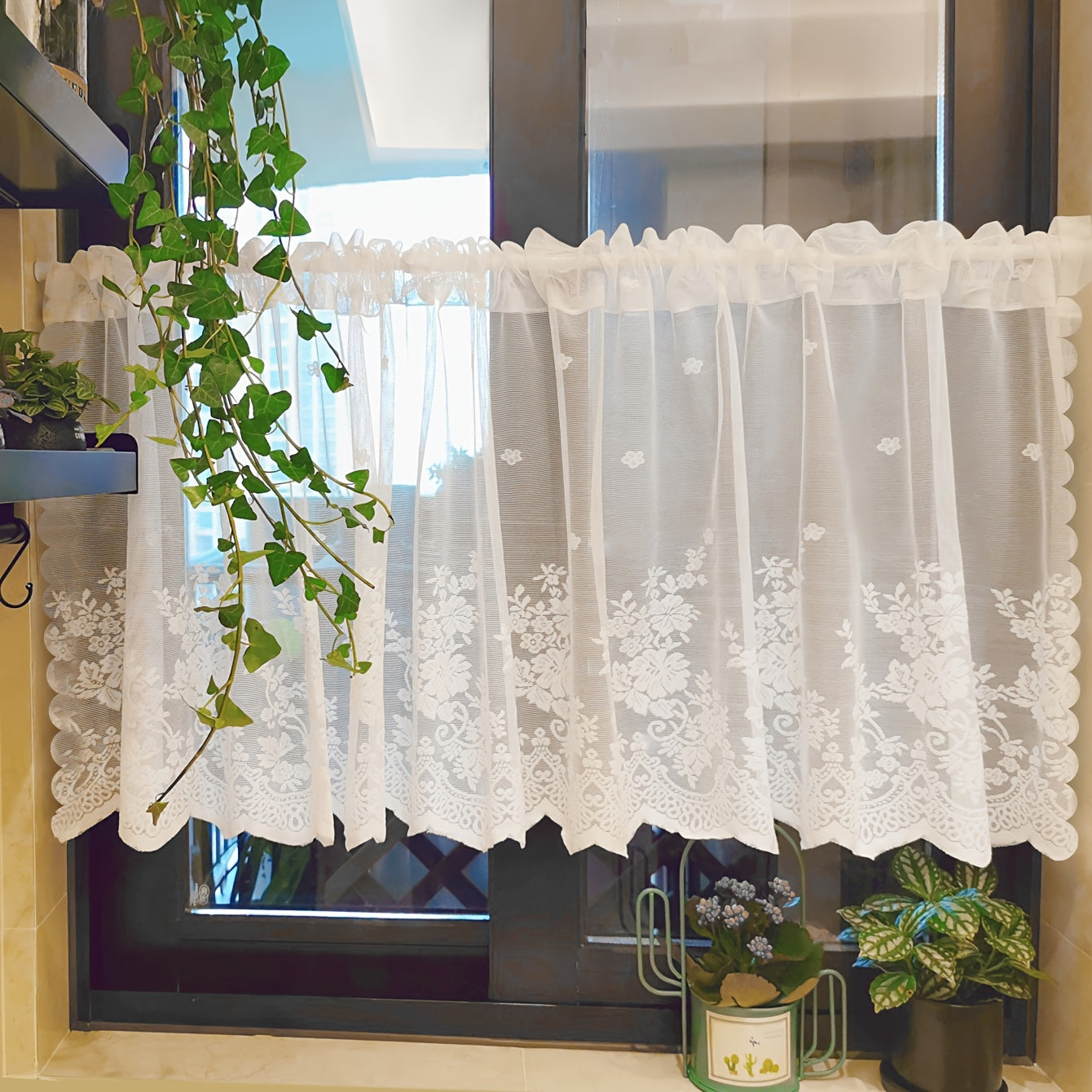 Elevate your space with this elegant black floral lace cafe curtain. Featuring a sweet and simple design, this curtain is made of sheer polyester and has a rod pocket for easy installation. Perfect for adding a touch of sophistication to your kitchen