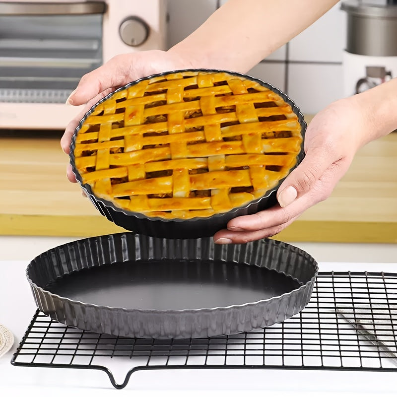 One piece of a round, black baking pan with a removable metal bottom and non-stick coating, perfect for baking pies, cakes, or cheese. Ideal for kitchen tools.