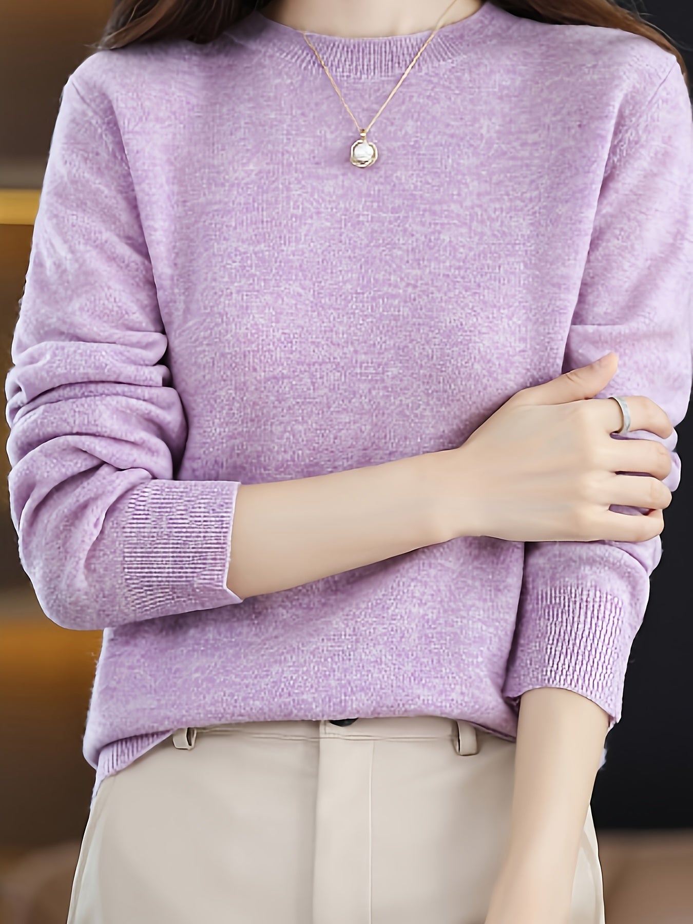 Stylish women's merino wool sweater with cozy crew neck, long sleeves, and solid color knit design for fall/winter.