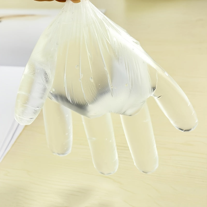 Disposable plastic BBQ gloves in a set of 90-100 pieces, transparent and designed to protect your hands while handling food for healthier cooking.