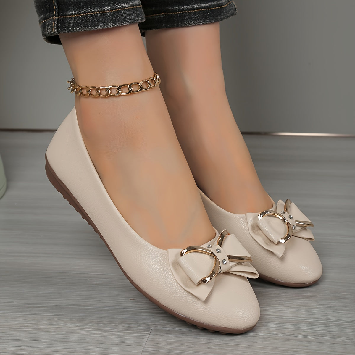 Casual flats for women with bow and rhinestone detail, round toe comfort, slip-on style, solid color.