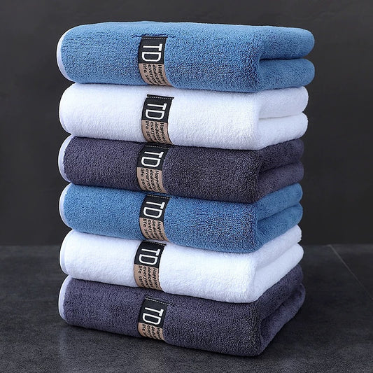 Set of 3 large microfiber bathroom face towels in blue, white, and dark teal with "D" label. Ultra-soft, super absorbent, quick-dry, low-lint, and five-star hotel grade.