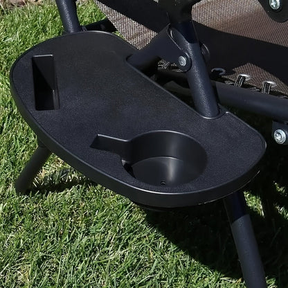 A modern black zero gravity chair accessory tray with cup holder and phone slot. Its durable clip-on design is perfect for lounging and beach recliners, and it is made of sturdy plastic.