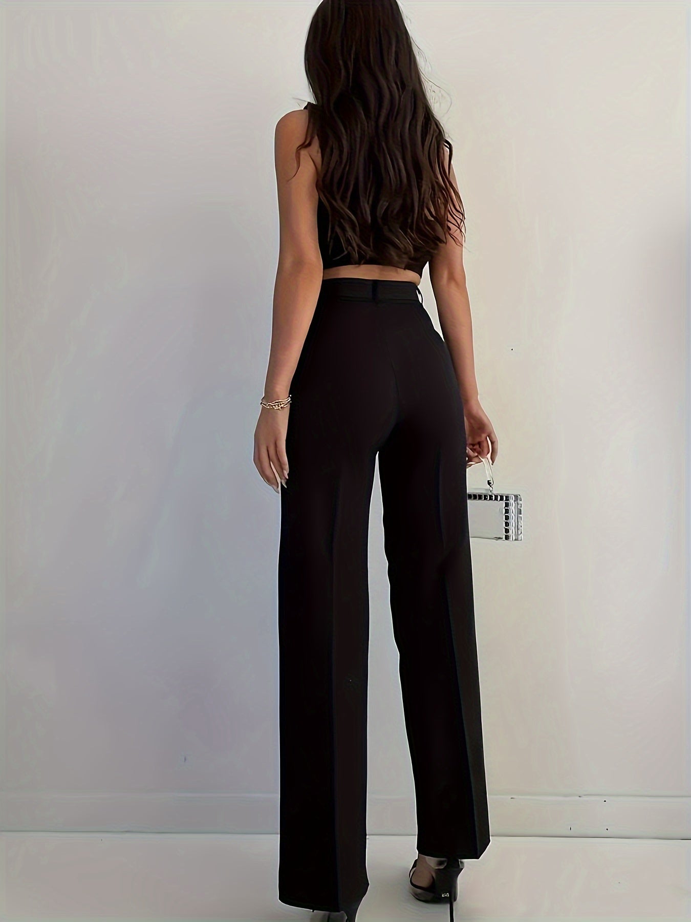 Stylish women's black pants, high-waisted, sleek polyester material, machine washable - suitable for professional and social occasions.