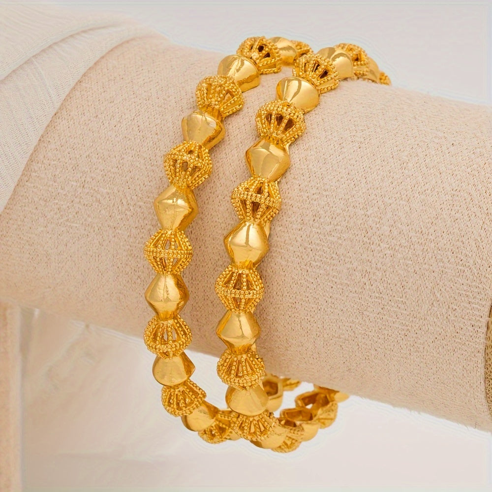 Two gold-tone alloy bangle bracelets that exude elegance and luxury fashion, inspired by Middle Eastern and African Nigerian styles. Perfect for weddings or daily wear, these versatile accessories are suitable for any season or occasion, including