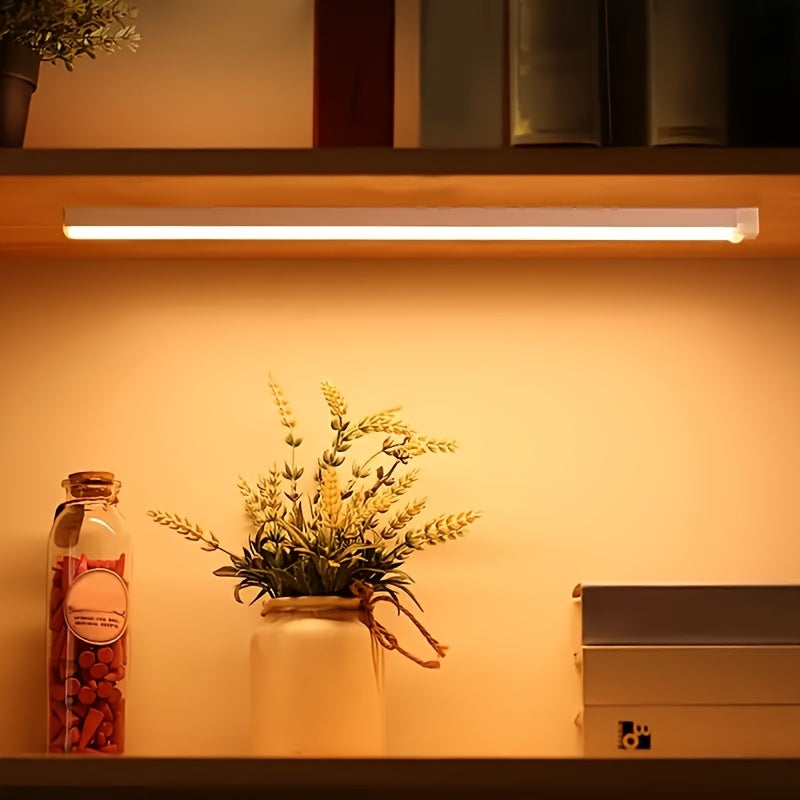 USB Rechargeable LED motion sensor light bar for indoor use. White plastic, energy efficient, and durable. Suitable for various spaces including walls, cabinets, pantries, staircases