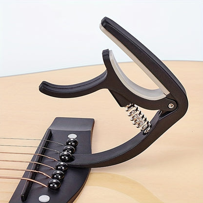 Quick change guitar capo clip for acoustic, classic, electric guitars, and ukulele. Universal adjustable clip.