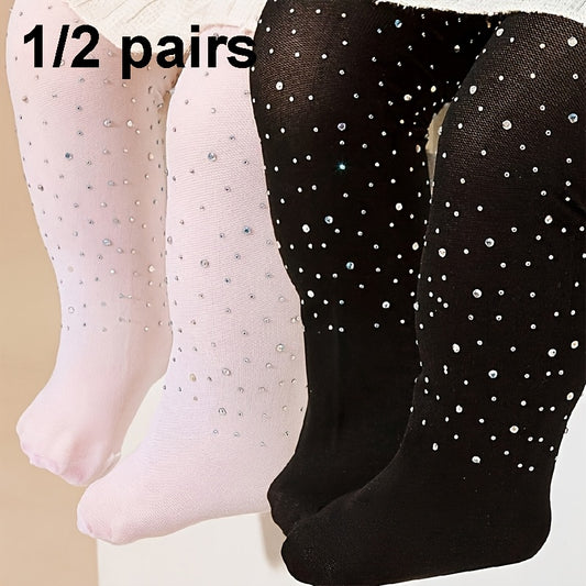 2 pairs of black and white rhinestone-studded tights for baby girls.